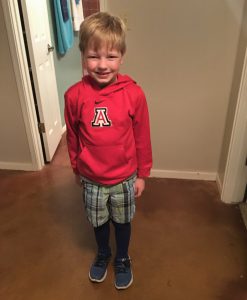 Photo of Dean in shorts with a hooded sweatshirt and soccer socks.