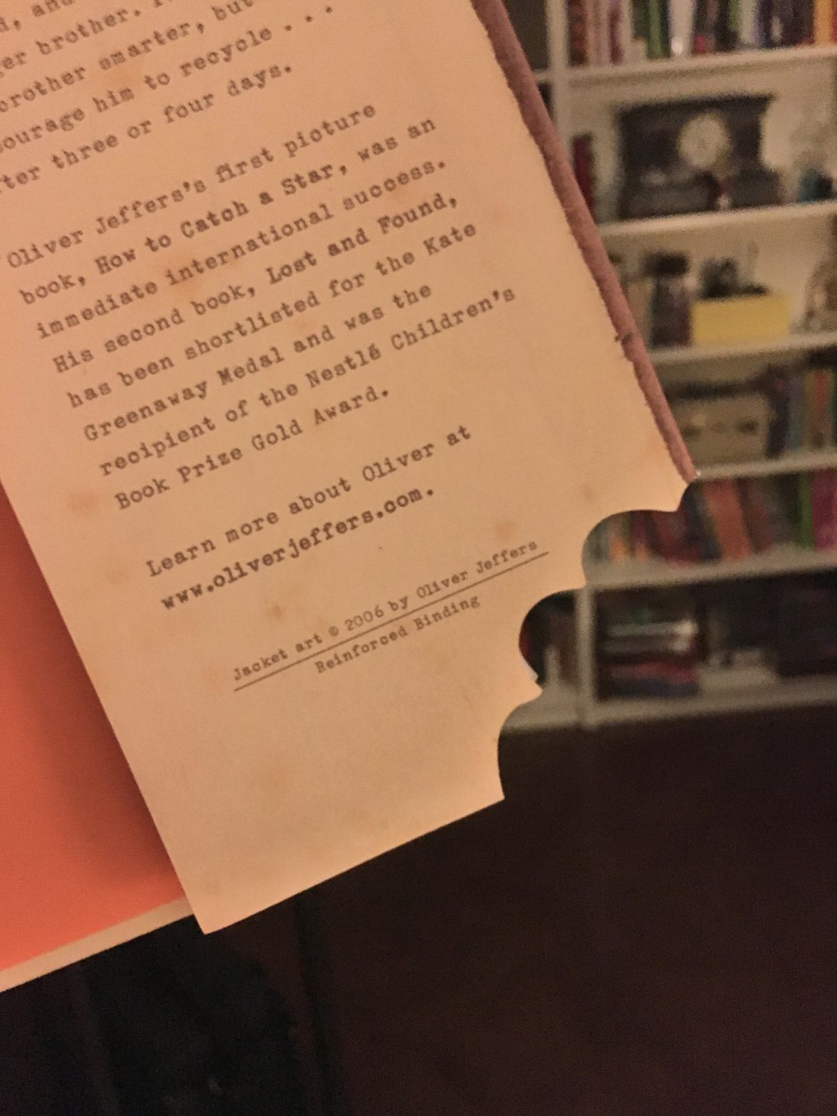 Photo of the back cover of a book with a fake bite taken out of it